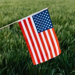 Crop anonymous patriot showing flag of United Stated of America