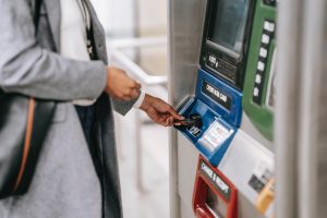 Close-up of person inserting bank card into ATM