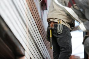 Man Wearing Black Denim Pants With Carrying Hammer on Holster, representing permanent whistleblower protections for contractors