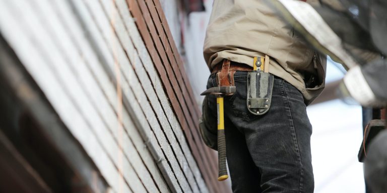 Man Wearing Black Denim Pants With Carrying Hammer on Holster, representing permanent whistleblower protections for contractors