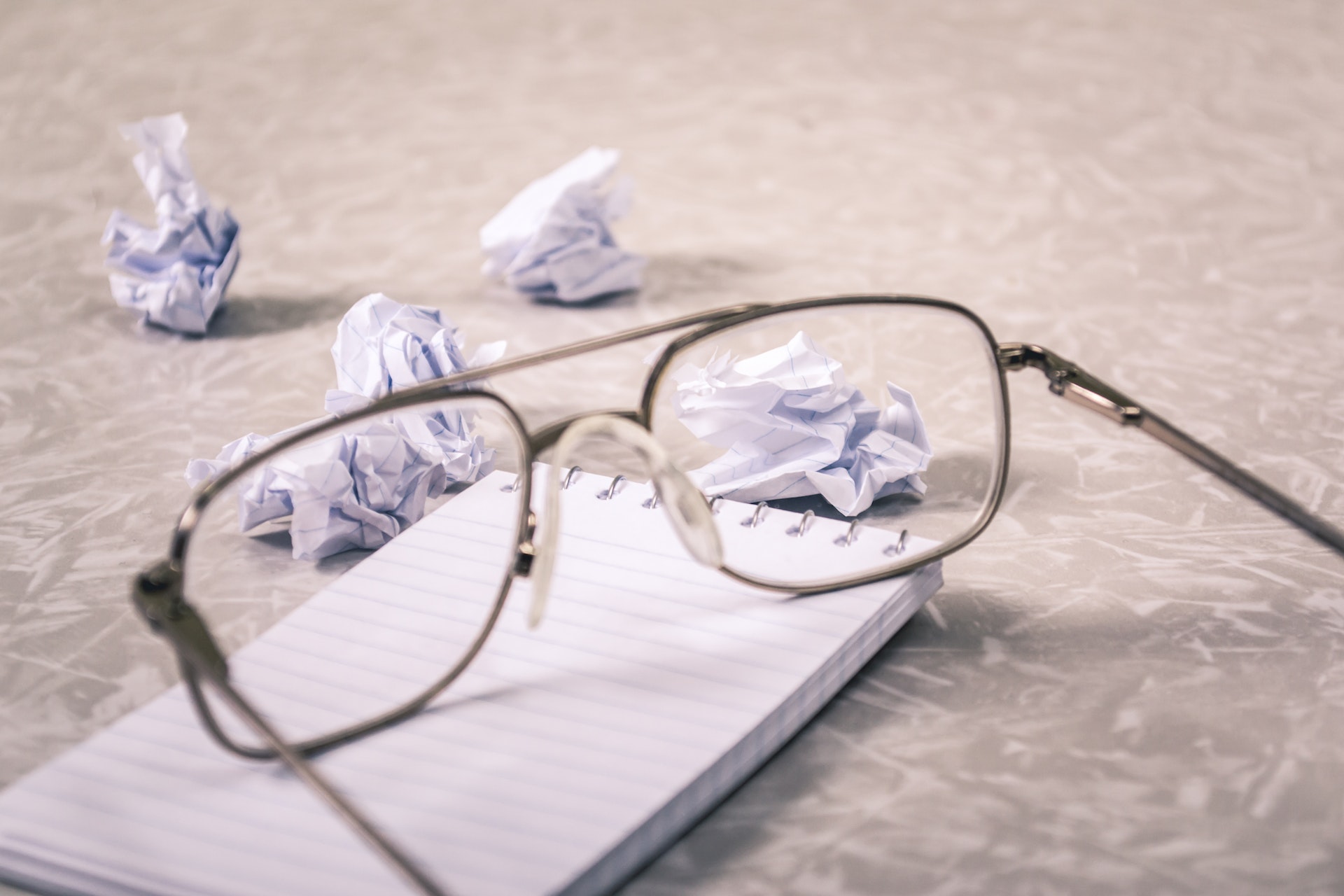 Glasses and Crumpled Paper, representing whistleblowing
