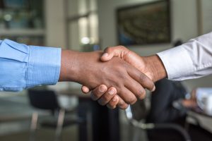 Two People Shaking Hands after False Claims Act Victory, representing Elder Care Fraud