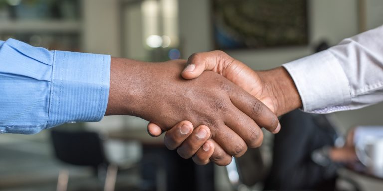 Two People Shaking Hands after False Claims Act Victory, representing Elder Care Fraud