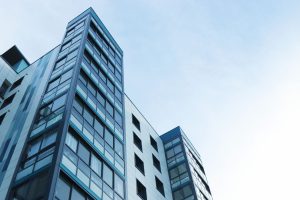 Low Angle View of Office Building Against Sky, representing Reverse Mortgage Whistleblower