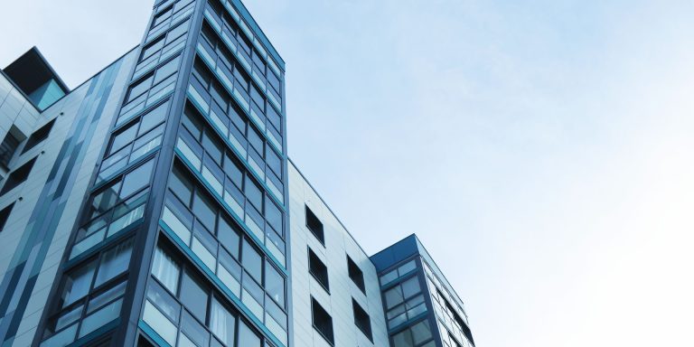 Low Angle View of Office Building Against Sky, representing Reverse Mortgage Whistleblower