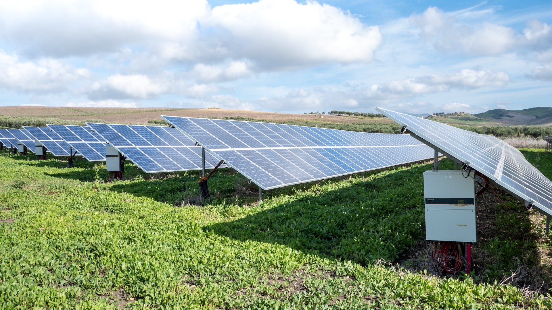 Photovoltaic PV plant ground mounted with string inverters, highlighting clean energy fraud