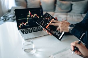 Person Holding a Black Digital Tablet, representing Fake News on Stocks