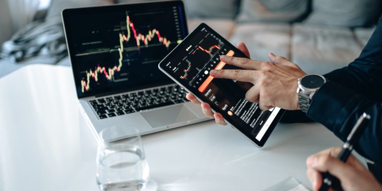 Person Holding a Black Digital Tablet, representing Fake News on Stocks