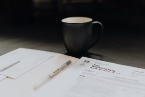 Accounting pages and a coffee mug, representing internal and external audits