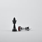 Battle - Two Silver Chess Pieces on White Surface