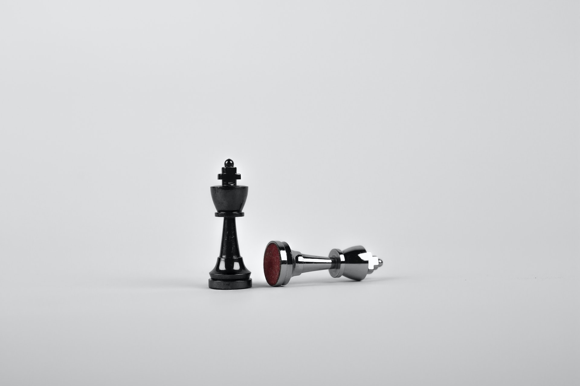 Battle - Two Silver Chess Pieces on White Surface