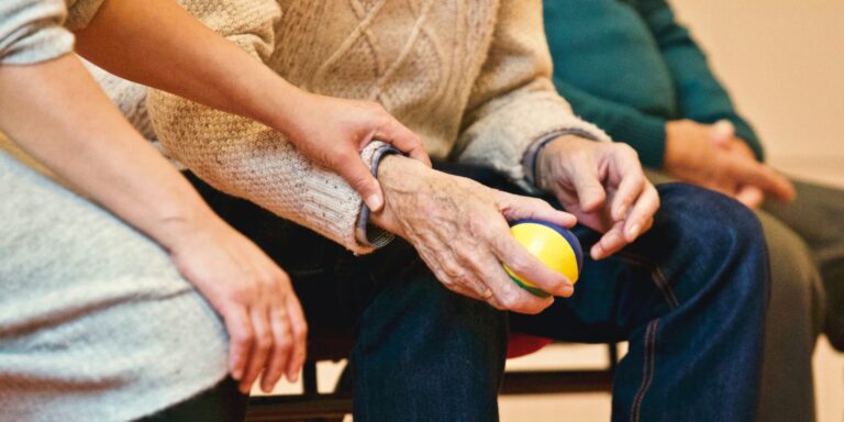 Closeup of hands of people in hospital waiting room