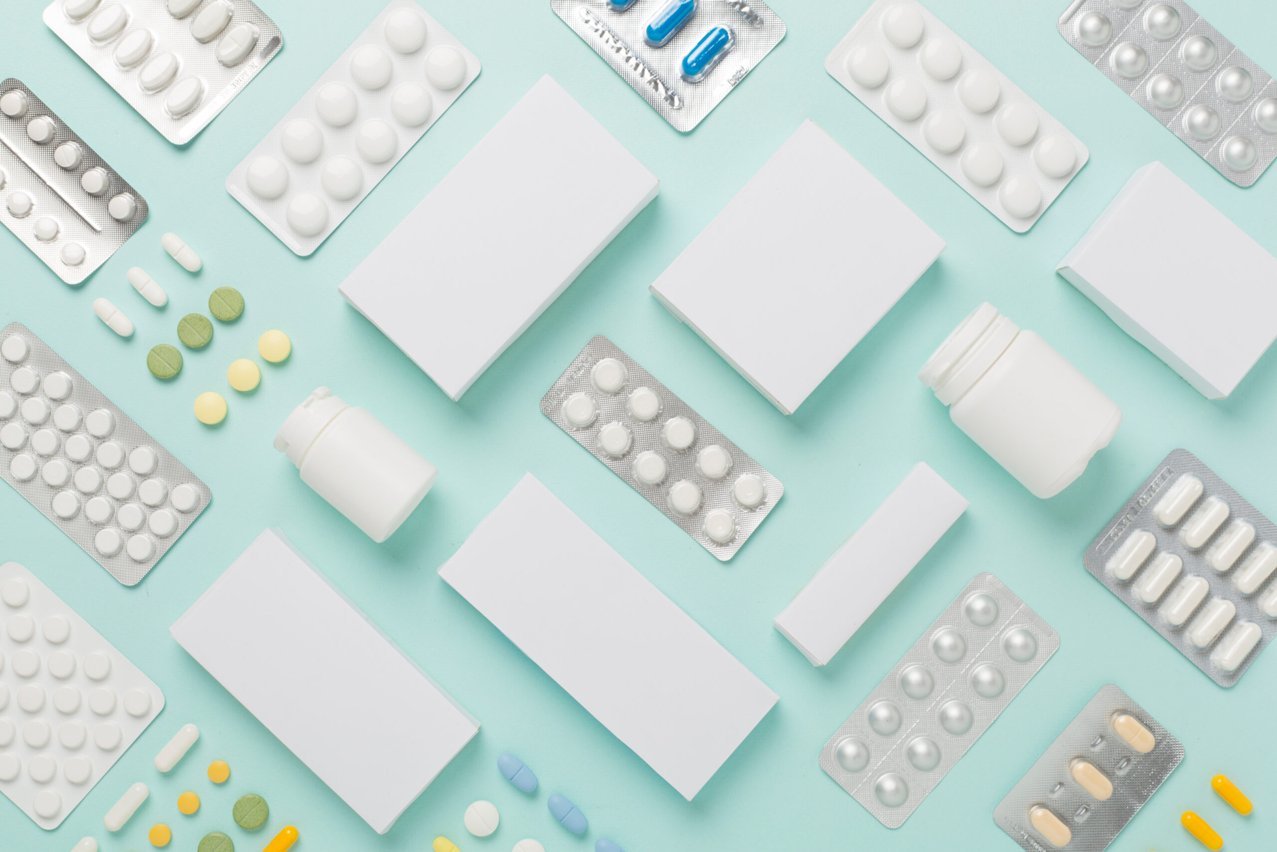 Flat lay with different pills in blister packaging and boxes and on color background, representing ERISA Lawsuit