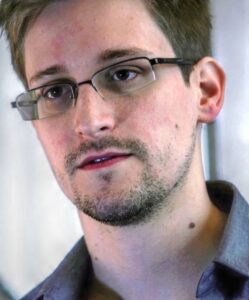 Edward Snowden wearing glasses and a collared shirt