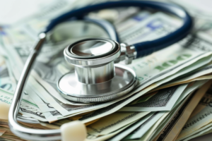 a stethoscope on top of money, representing Healthcare Whistleblower Attorney Helps Secure $1.2 Million from Dr. Modh and PPM